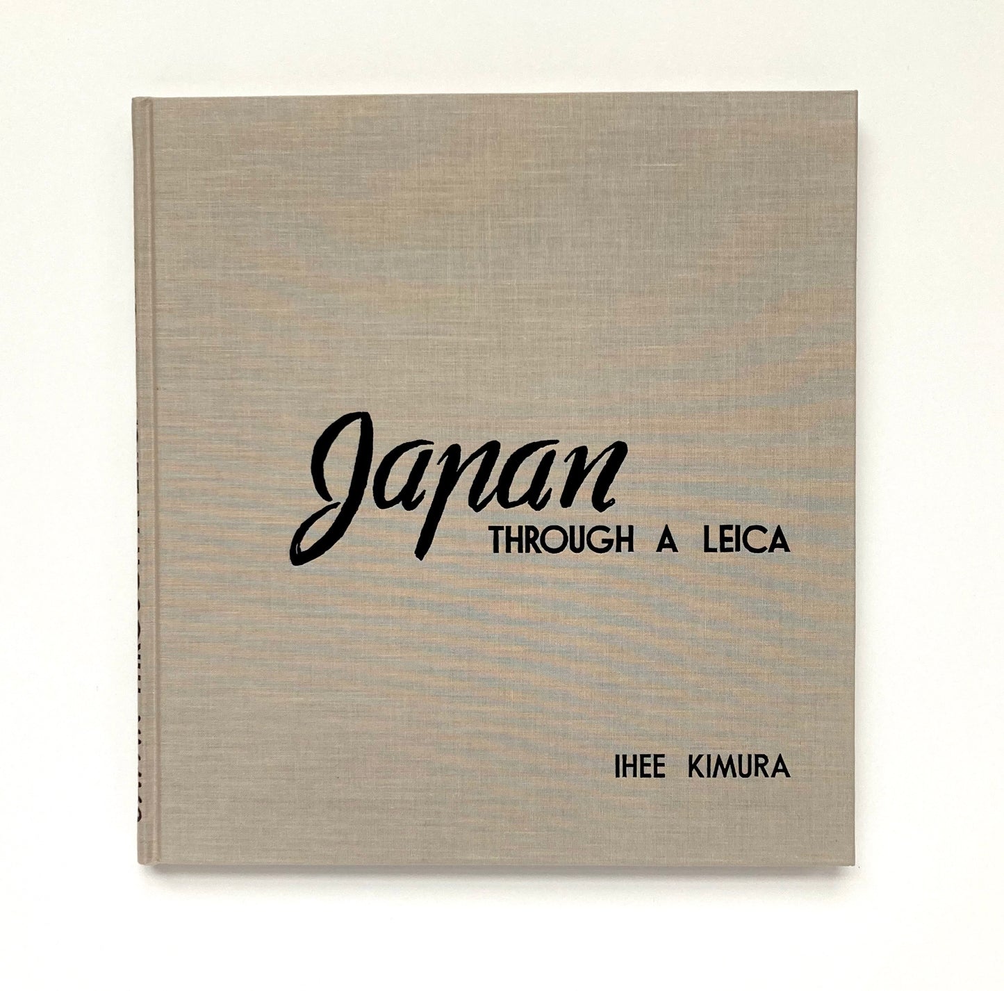 Book titled 'Japan Through a Leica' by Ihée Kimura on a white background