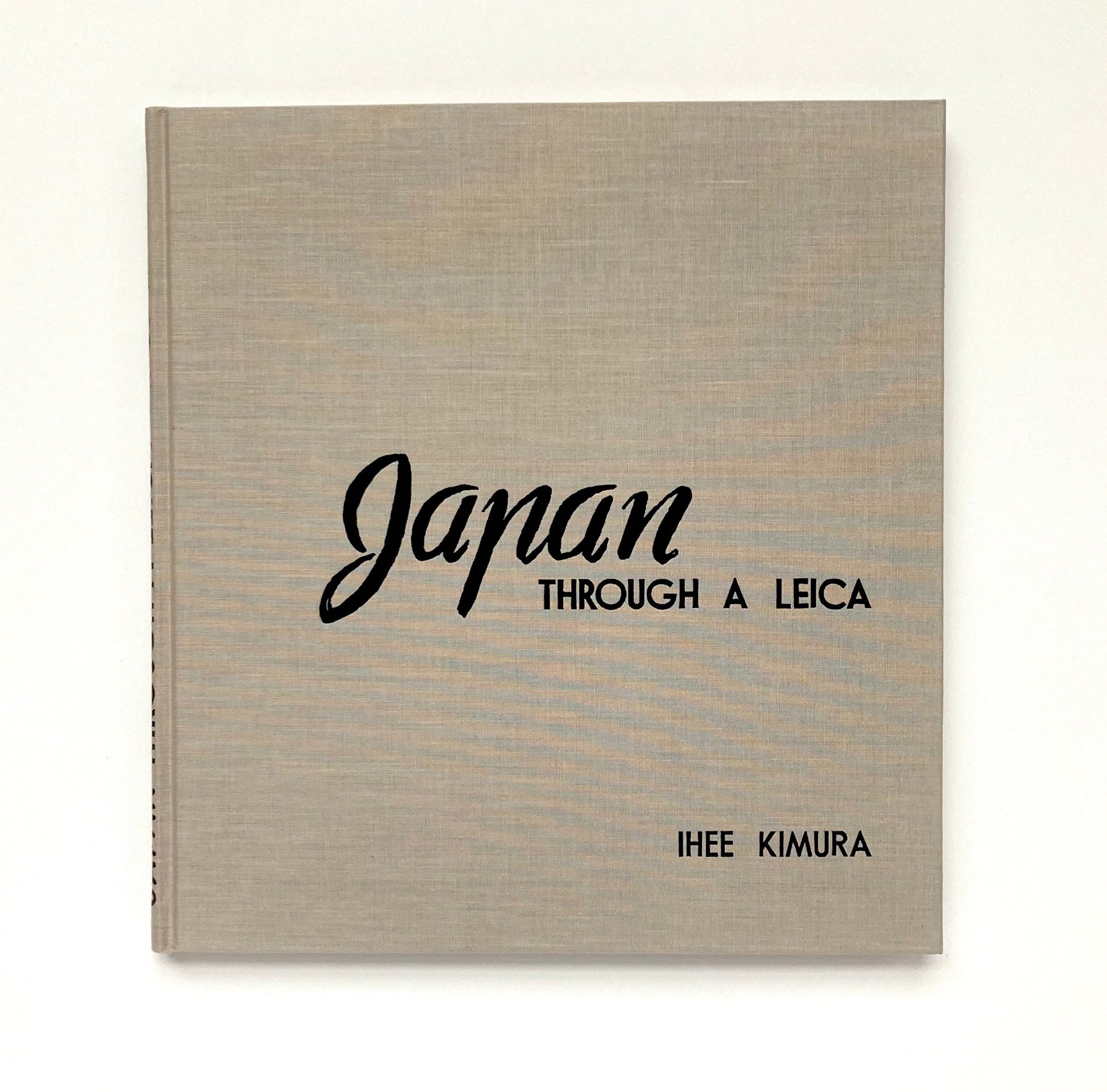 Book titled 'Japan Through a Leica' by Ihée Kimura on a white background
